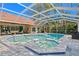 A luxurious screened-in pool and spa are surrounded by ample deck space for lounging at 5035 Pinelake Rd, Wesley Chapel, FL 33543