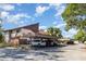 Exterior view of home featuring covered parking with several vehicles and mature landscaping at 6022 Red Maple Rd # 1107, Bradenton, FL 34210