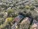 An aerial view of a home surrounded by mature trees in a residential neighborhood at 6125 Gannetwood Pl, Lithia, FL 33547