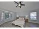 Stylish bedroom with a ceiling fan and natural light from multiple windows at 6125 Gannetwood Pl, Lithia, FL 33547