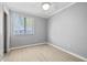 Cozy bedroom with neutral paint, hardwood floors, and natural light from a large window at 622 Bay Lake Trl, Oldsmar, FL 34677