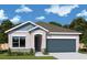 Charming single-story home with a two-car garage, landscaped yard, and classic architectural details at 6270 Little Gem Ct, Apollo Beach, FL 33572