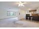 Bright, open living space with kitchen bar seating, with neutral walls, and carpeted flooring at 737 Bay Vista S Blvd, St Petersburg, FL 33705