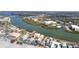Stunning aerial view showcases waterfront homes, beach access, and nearby bridge at 74 Gulf Blvd # 1B, Indian Rocks Beach, FL 33785