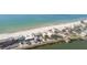 Panoramic aerial view showcases houses along the beach with stunning water access at 74 Gulf Blvd # 1B, Indian Rocks Beach, FL 33785