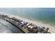 Aerial view highlights the property's location along a beautiful beach and waterfront at 74 Gulf Blvd # 1B, Indian Rocks Beach, FL 33785