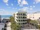 Aerial view of condo building showcasing private balconies and palm trees at 74 Gulf Blvd # 1B, Indian Rocks Beach, FL 33785