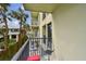 Private balcony offers tranquil outdoor seating and views of tropical palm trees at 74 Gulf Blvd # 1B, Indian Rocks Beach, FL 33785
