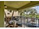 Relax on the covered balcony with comfortable seating and enjoy the views of the surrounding area at 74 Gulf Blvd # 1B, Indian Rocks Beach, FL 33785