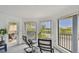Balcony seating area offering stunning views of the community and lush landscaping at 74 Gulf Blvd # 1B, Indian Rocks Beach, FL 33785