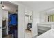 Bathroom featuring modern tiled floors, vanity, a shower with a curtain and an open closet on the left at 74 Gulf Blvd # 1B, Indian Rocks Beach, FL 33785