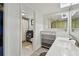 Well-lit bathroom featuring tiled floors, a sink, and a toilet, complemented by a shower with a curtain at 74 Gulf Blvd # 1B, Indian Rocks Beach, FL 33785