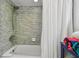 Bathroom featuring modern tiled shower, towels, and a toilet at 74 Gulf Blvd # 1B, Indian Rocks Beach, FL 33785