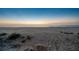 Tranquil beach view featuring soft sand, calm waves, and a peaceful horizon, promoting relaxation at 74 Gulf Blvd # 1B, Indian Rocks Beach, FL 33785