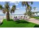 Lounge seating area with beach access with manicured green space and palm trees at 74 Gulf Blvd # 1B, Indian Rocks Beach, FL 33785