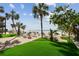 Lounge seating area with beach access with manicured green space and palm trees at 74 Gulf Blvd # 1B, Indian Rocks Beach, FL 33785