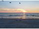 Picturesque beach view with gentle waves at sunset, emphasizing the serene coastal setting at 74 Gulf Blvd # 1B, Indian Rocks Beach, FL 33785