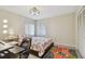 This well-lit bedroom includes a comfortable bed, a stylish ceiling fan, and ample closet space at 74 Gulf Blvd # 1B, Indian Rocks Beach, FL 33785