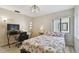 Bright bedroom featuring a comfortable bed, modern lighting, and a convenient workspace area at 74 Gulf Blvd # 1B, Indian Rocks Beach, FL 33785