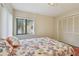 Bright bedroom featuring an ocean themed comforter, window and closet space at 74 Gulf Blvd # 1B, Indian Rocks Beach, FL 33785