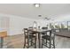 Open concept living area with a gray dining set and views to the exterior balcony at 74 Gulf Blvd # 1B, Indian Rocks Beach, FL 33785