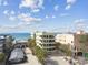 Stunning exterior view of condo building with multiple balconies with a glimpse of ocean views at 74 Gulf Blvd # 1B, Indian Rocks Beach, FL 33785