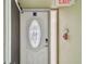 Elegant white front door with decorative glass and a secure keypad entry system at 74 Gulf Blvd # 1B, Indian Rocks Beach, FL 33785