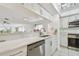 Modern kitchen with stainless steel appliances, white cabinetry, and an open layout at 74 Gulf Blvd # 1B, Indian Rocks Beach, FL 33785