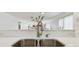 Modern stainless steel sink with quartz countertops looking into open-concept living area at 74 Gulf Blvd # 1B, Indian Rocks Beach, FL 33785