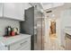 Kitchenette boasts stainless steel refrigerator and modern appliances, complemented by sleek white countertops at 74 Gulf Blvd # 1B, Indian Rocks Beach, FL 33785