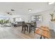 Sunlit open-concept living area with modern furnishings, stylish flooring, and dining area at 74 Gulf Blvd # 1B, Indian Rocks Beach, FL 33785