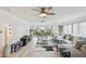Inviting living room boasts a ceiling fan, neutral tones, and access to the balcony at 74 Gulf Blvd # 1B, Indian Rocks Beach, FL 33785