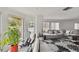 Open-concept living space with access to a private balcony and neutral tones at 74 Gulf Blvd # 1B, Indian Rocks Beach, FL 33785