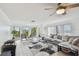Cozy living room with floor to ceiling windows and glass door access to a balcony at 74 Gulf Blvd # 1B, Indian Rocks Beach, FL 33785