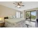 Cozy main bedroom with a ceiling fan, and a balcony at 74 Gulf Blvd # 1B, Indian Rocks Beach, FL 33785