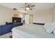 Cozy main bedroom with a ceiling fan, with an open doorway, and a TV set at 74 Gulf Blvd # 1B, Indian Rocks Beach, FL 33785