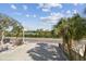 Open parking lot with trees and view to waterway at 74 Gulf Blvd # 1B, Indian Rocks Beach, FL 33785