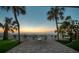 Relaxing outdoor patio with elegant seating, showcasing the beautiful beach and scenic palm trees at 74 Gulf Blvd # 1B, Indian Rocks Beach, FL 33785