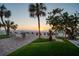 Inviting outdoor patio featuring lush landscaping, lounge chairs, and a serene ocean view at 74 Gulf Blvd # 1B, Indian Rocks Beach, FL 33785