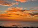 Scenic ocean sunset view with vibrant orange sky, highlighting a beautiful beach at 74 Gulf Blvd # 1B, Indian Rocks Beach, FL 33785
