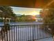Balcony view features a scenic water view at sunset, emphasizing the property's setting at 74 Gulf Blvd # 1B, Indian Rocks Beach, FL 33785