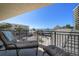 Relaxing balcony view of the beach, buildings, and ocean, complete with lounge chairs at 7600 Bayshore Dr # 204, Treasure Island, FL 33706