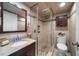 Neutral bathroom showcasing a tiled shower, vanity with granite counters and a commode at 7600 Bayshore Dr # 204, Treasure Island, FL 33706