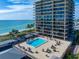 High-rise condo building with large balconies and a pool deck overlooking the ocean at 7600 Bayshore Dr # 204, Treasure Island, FL 33706