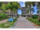 Welcoming entrance to a private condominium property featuring manicured landscaping and secure access at 7600 Bayshore Dr # 204, Treasure Island, FL 33706