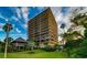 Striking multi-story building featuring private balconies and lush tropical landscaping at 7600 Bayshore Dr # 204, Treasure Island, FL 33706