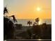 Picturesque sunset behind a building and palm trees at 7600 Bayshore Dr # 204, Treasure Island, FL 33706