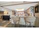 Charming kitchen features a breakfast bar with granite countertops and stainless steel appliances at 7600 Bayshore Dr # 204, Treasure Island, FL 33706