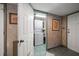 Open laundry room with a stacked washer and dryer and built in shelving at 7600 Bayshore Dr # 204, Treasure Island, FL 33706