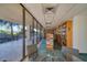 Cozy library features floor to ceiling windows overlooking palm trees and various books at 7600 Bayshore Dr # 204, Treasure Island, FL 33706